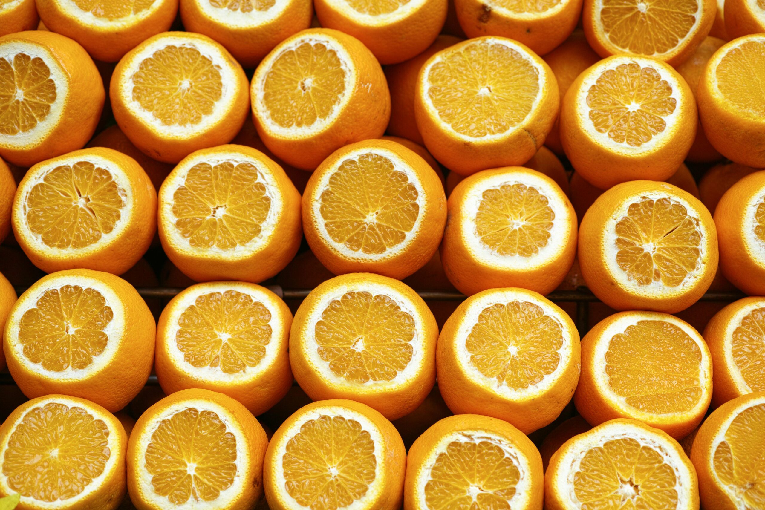 A vibrant array of freshly cut oranges showcasing their juicy interior. Perfect for healthy lifestyle themes.
